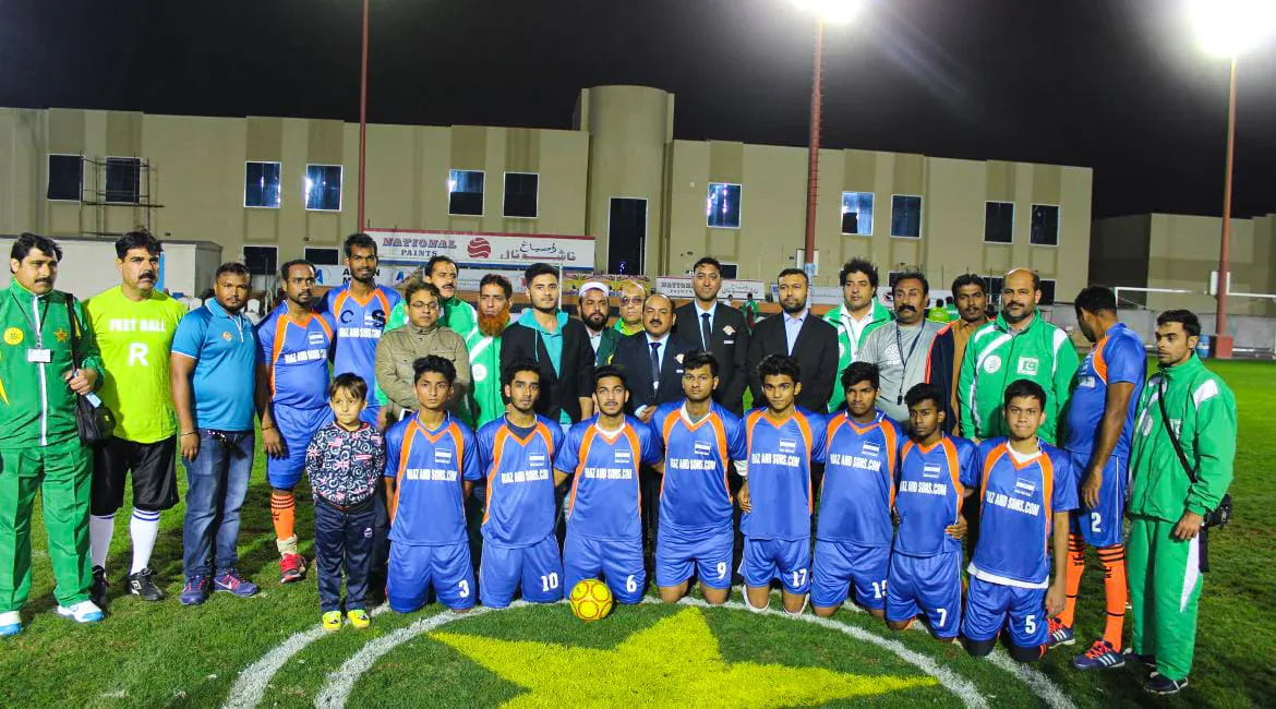 Full squads and officials gathered over the centre star at a floodlit Feetball fixture