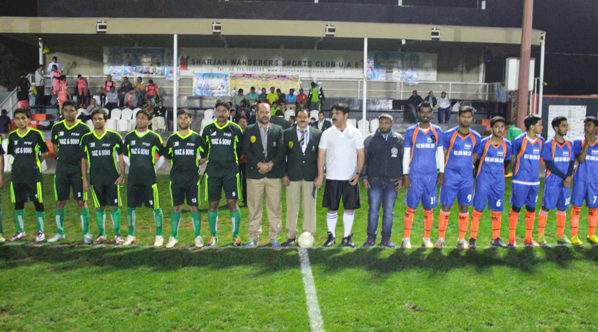Two Feetball squads lined up with match officials before kick-off